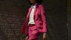 John Lewis stock image of woman in a pink suit