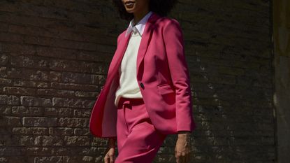 John Lewis stock image of woman in a pink suit