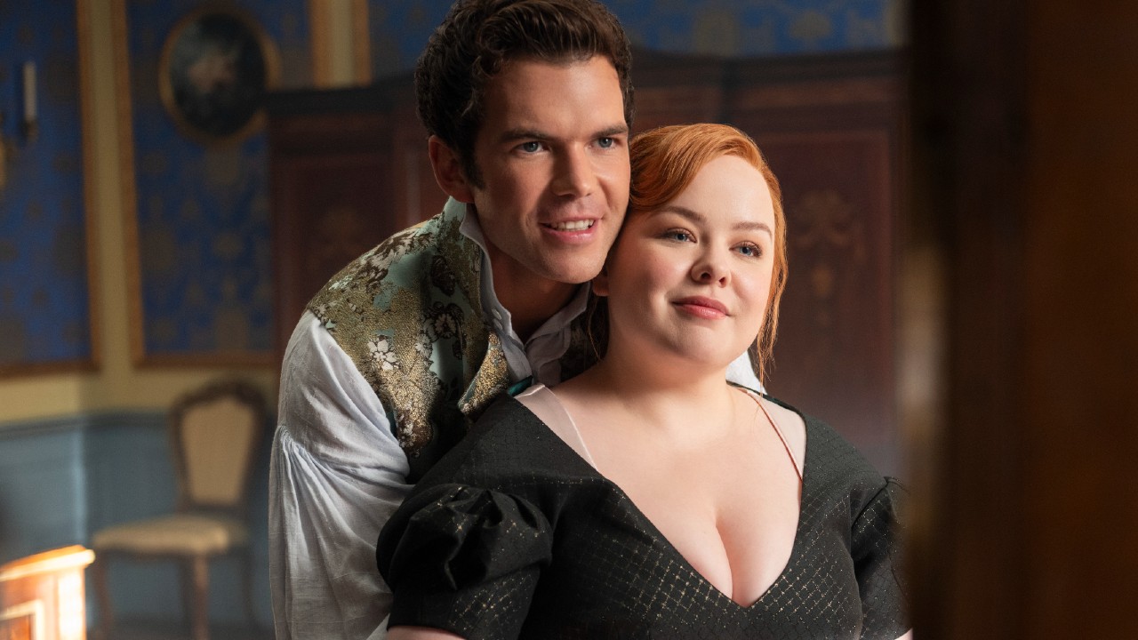 Colin holding Penelope as they look in a mirror.