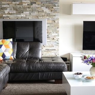 living room with black leather sofa