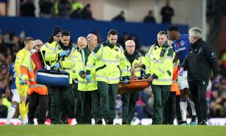 Andre Gomes is carried off the field after suffering a horrific injury against Tottenham last month