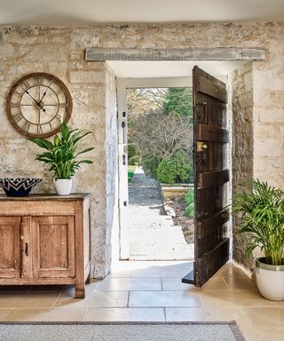 kitchen with exposed stone walls in Grade II* listed 12th century Cotswolds country house