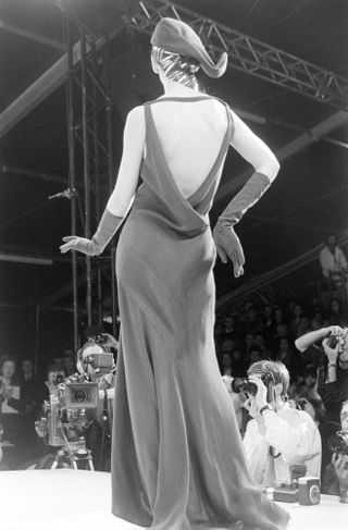 A model wearing a black bias-cut gown during John Galliano Fall 1988 Ready to Wear Fashion Show