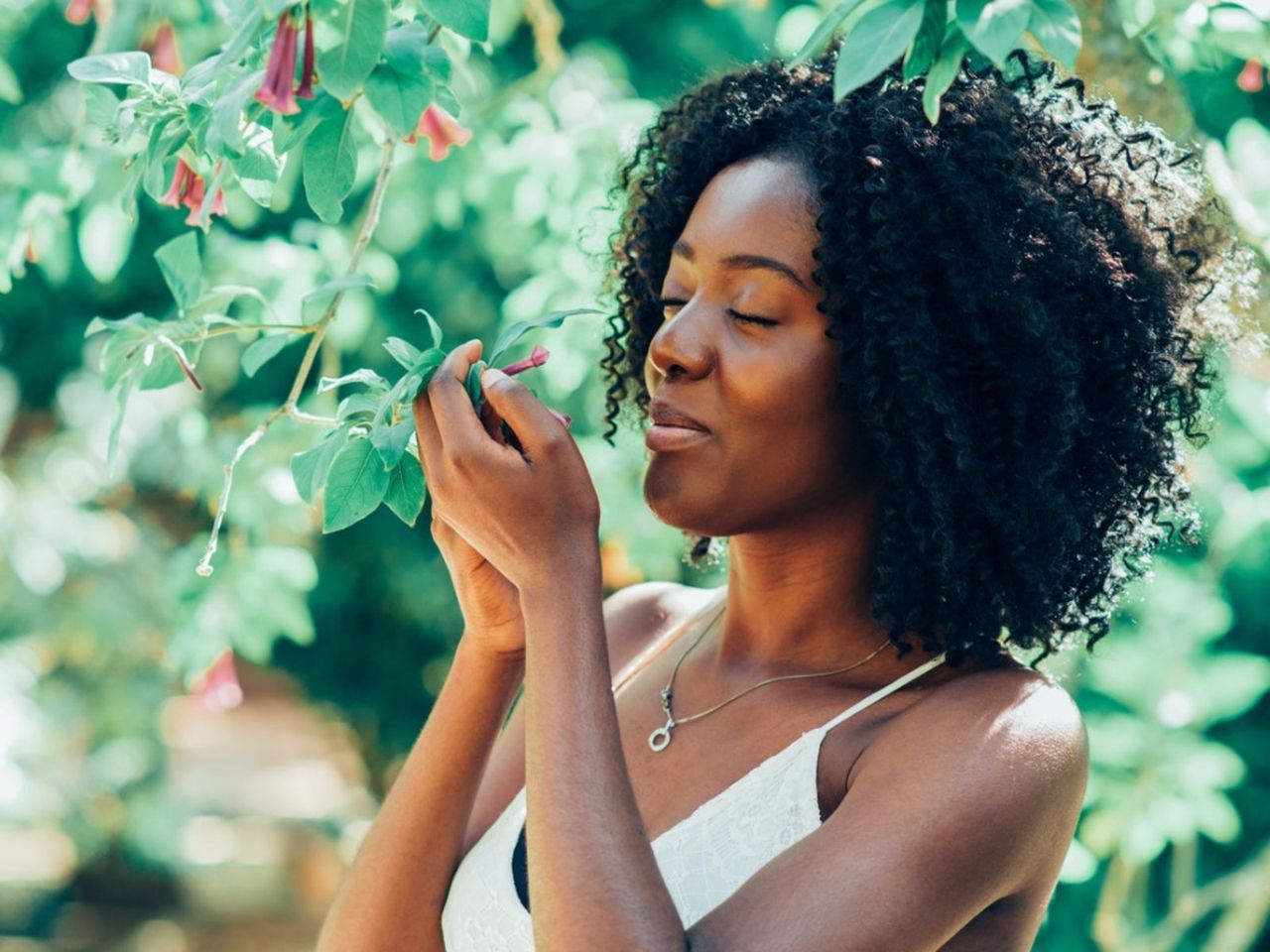 A Woman Smelling Flowers