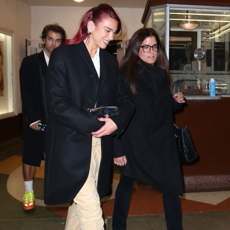 Dua Lipa wearing an oversized black blazer with khaki pants 