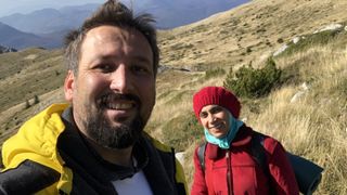 A couple takes a selfie while hiking