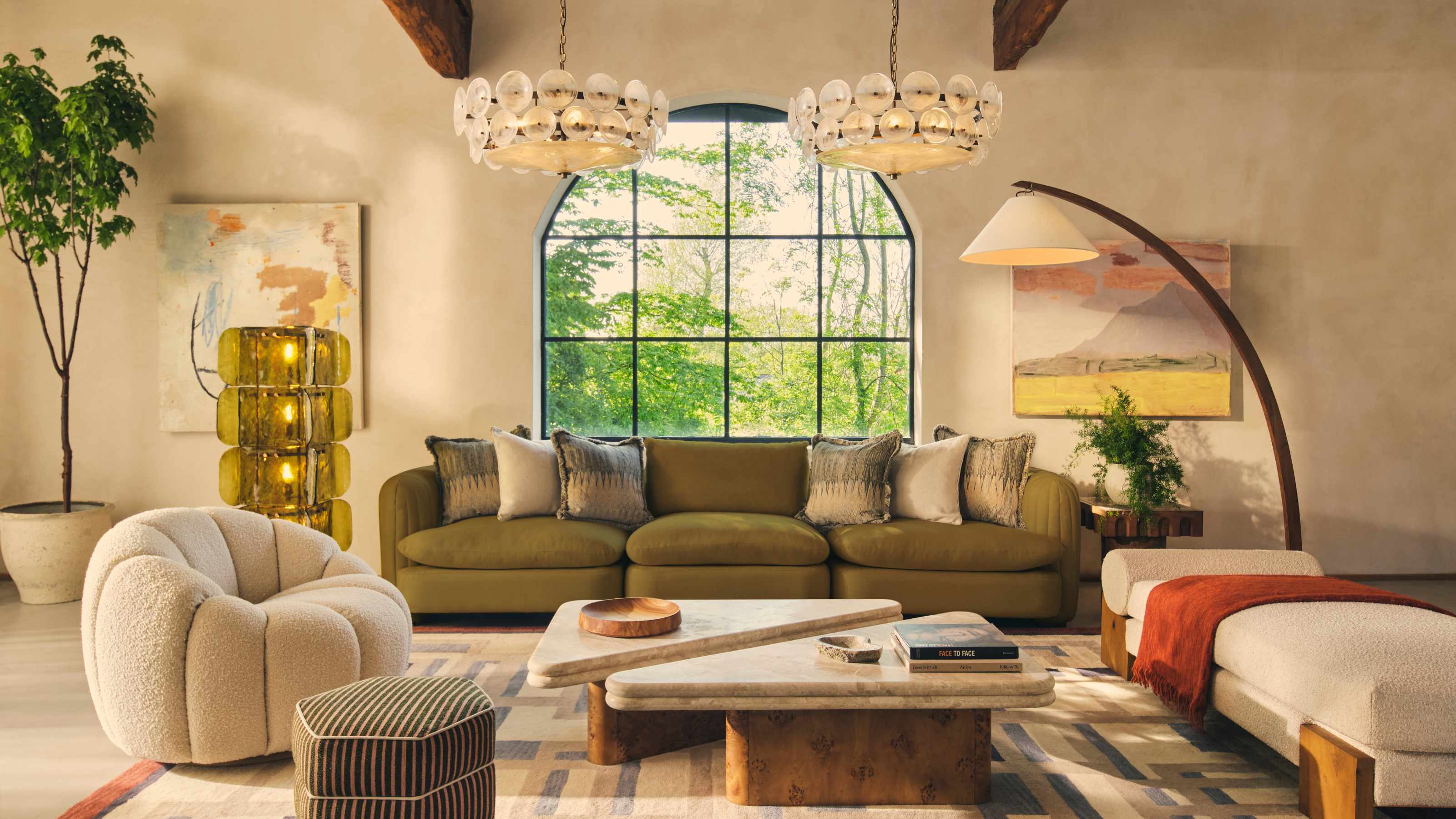 a large living room with a huge window and lots of layered lighting