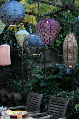 Large outdoor lanterns hanging from tree