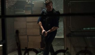 Olympus Has Fallen Gerard Butler patrols a hallway with a gun