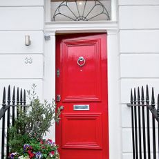 red door entrance with white wall