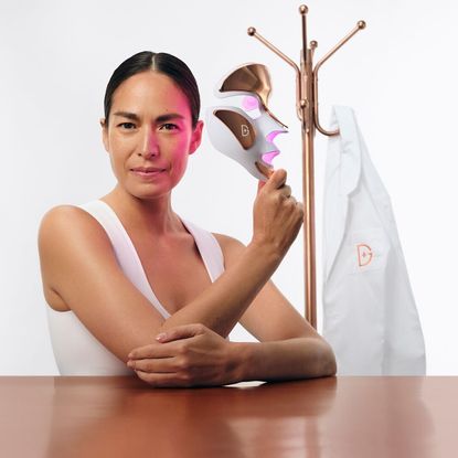 Woman holding a electronic skincare mask