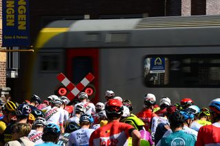 HARELBEKE BELGIUM MARCH 25 The peloton stopped due to a train crossing during the 65th E3 Saxo Bank Classic 2022 a 2039km one day race from Harelbeke to Harelbeke E3SaxobankClassic WorldTour on March 25 2022 in Harelbeke Belgium Photo by Tim de WaeleGetty Images