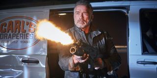 T-800/Carl (Arnold Schwarzenegger) blasts a weapon in Terminator: Dark Fate (2019)