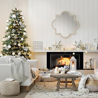 living area with fireplace and white sofa with and christmas tree