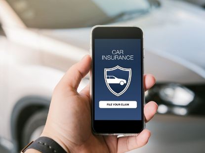 Person holding smartphone with the words car insurance on it