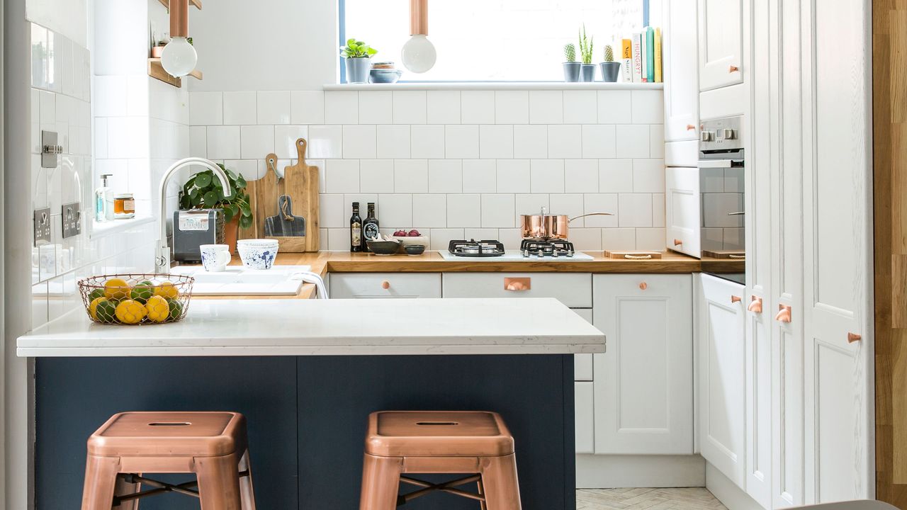 white kitchen with tiles and copper accents