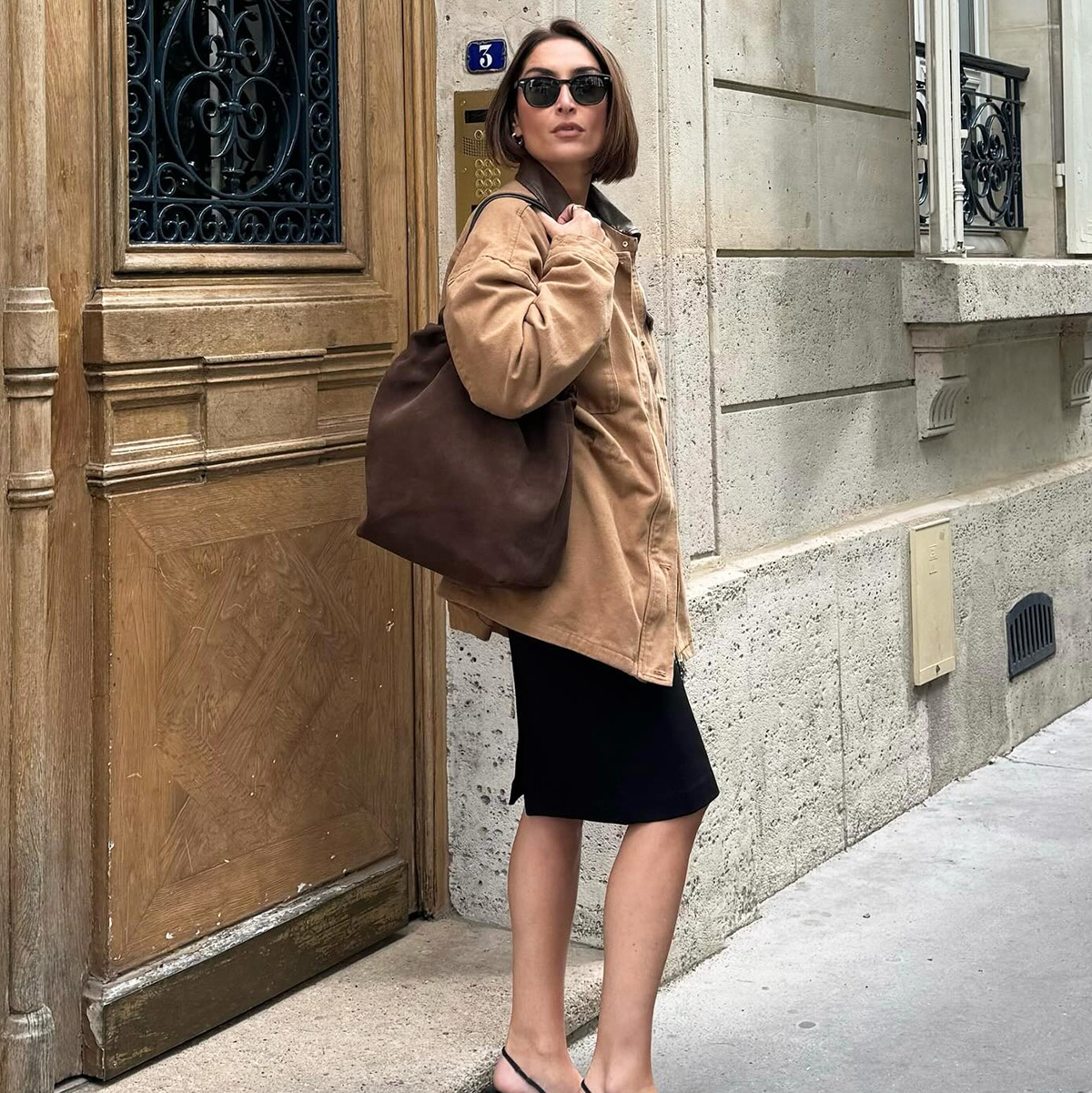 French influencer wearing a black knee-length skirt