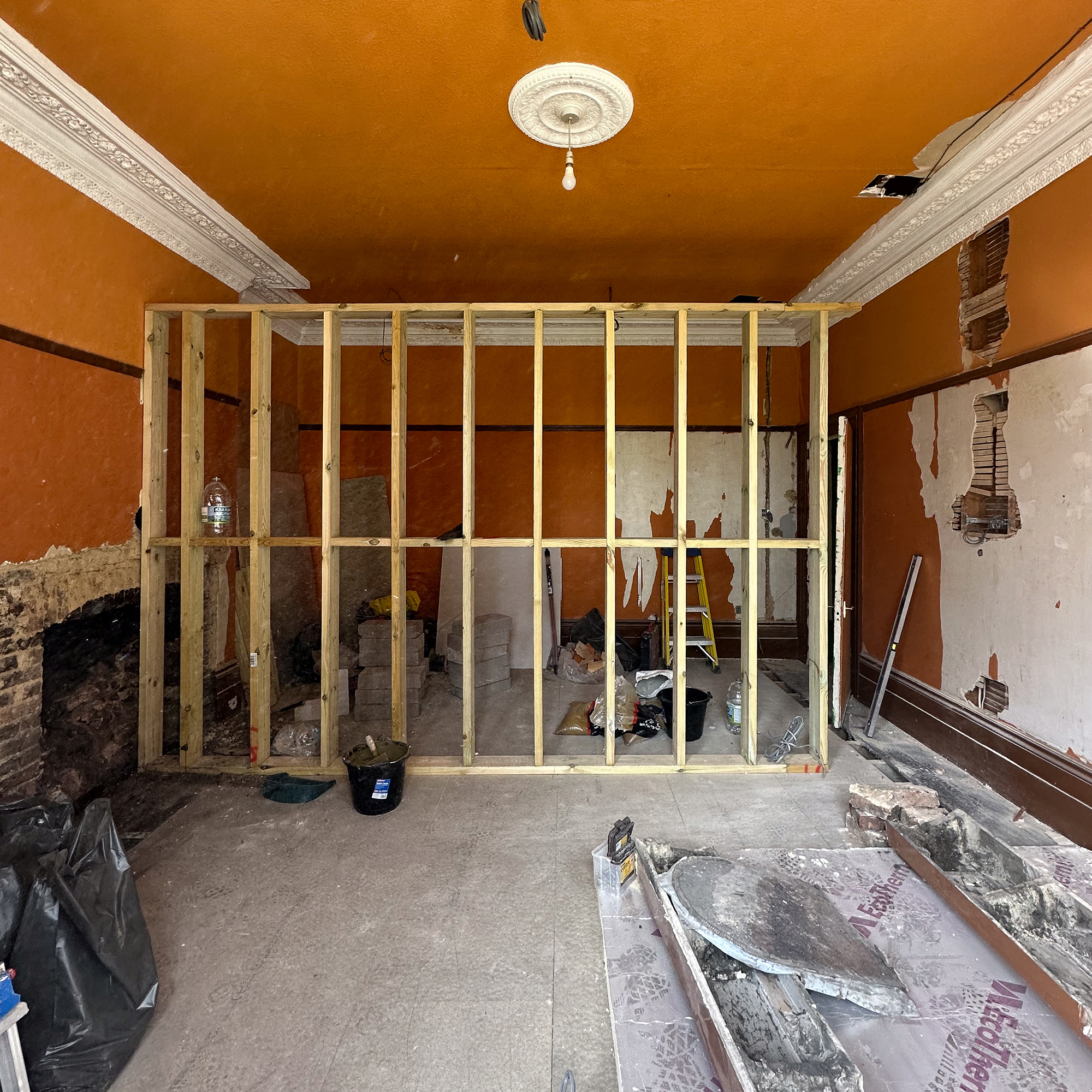 bedroom with partition wall being installed during a renovation