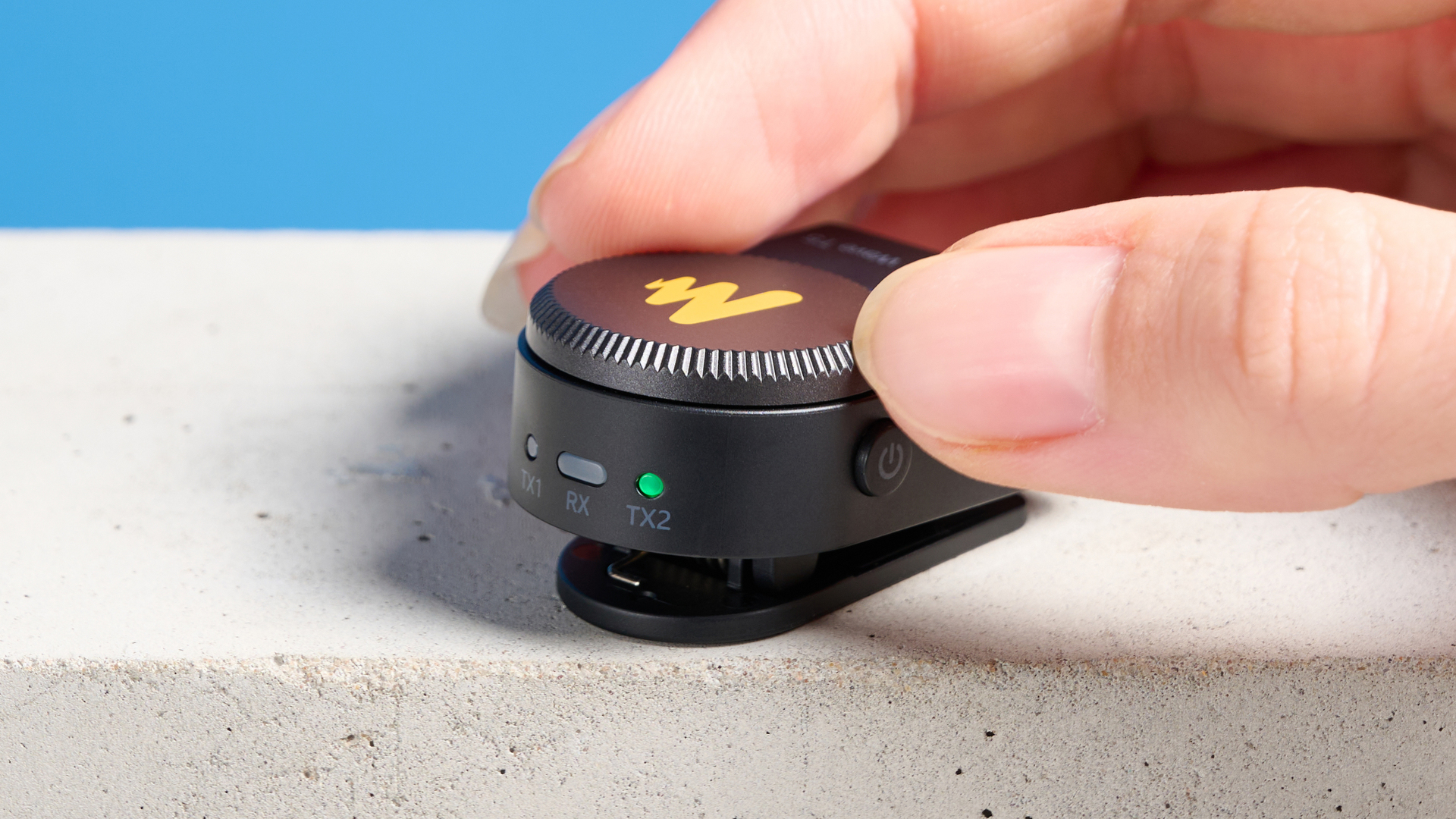 the maono wave t5 lavalier microphone shown against a blue background, showing the transmitters, receivers, and charging case