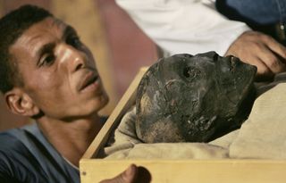 This photo shows the mummy of Tutankhamun being moved during conservation work. King Tut's mummy has been "significantly altered" from how he looked during his lifetime, so it's difficult to make an accurate reconstruction of him.