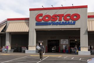 A person wearing a protective mask exits a Costco store in Richmond, California, U.S., on Wednesday, March 3, 2021.