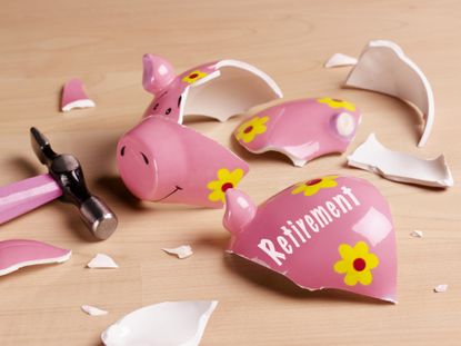 Broken pink piggy bank that says retirement 