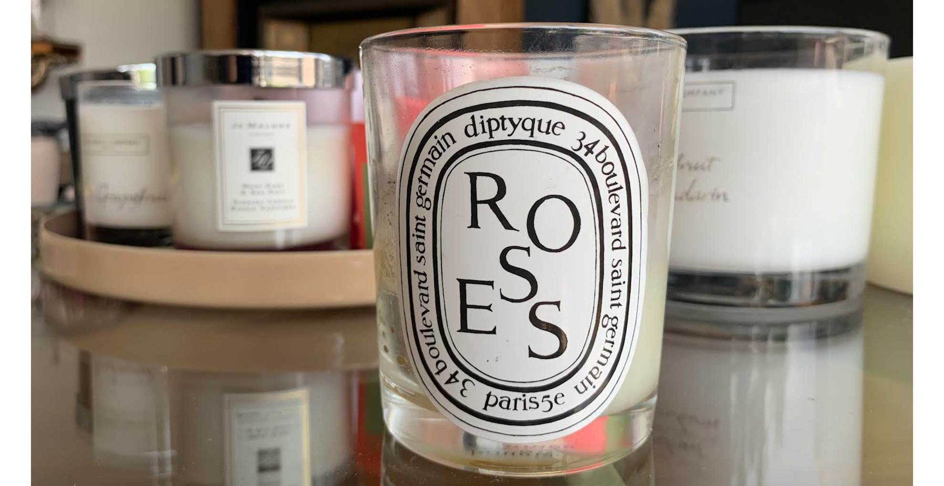 glass coffee table filled with scented candles used for scent-scaping