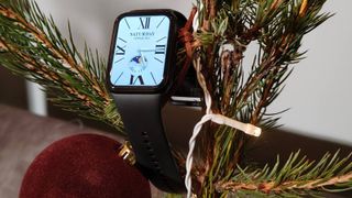 The Xiaomi Smart Band 9 Pro hanging on a Christmas tree