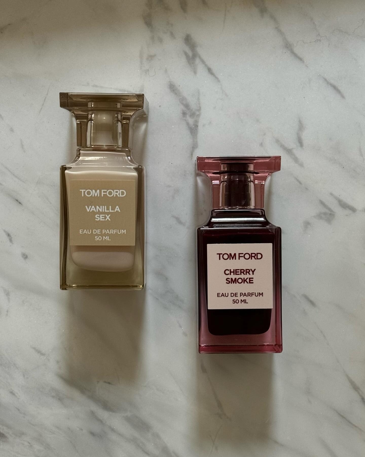 A picture of two Tom Ford perfumes on a marble background