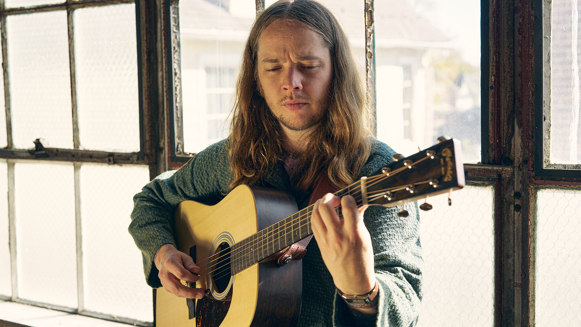A promo photo for the Martin DX-2E Billy Strings acoustic-electric guitar
