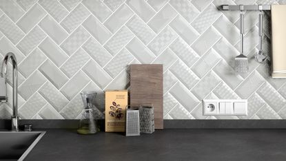Textured grey tiles as a kitchen splashback