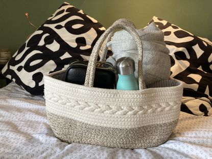Diaper caddy used to keep everyday items together including water bottle and cardigan