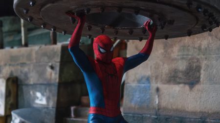 Spider-Man: Brand New Day photo of Spider-Man lifting a heavy metal object