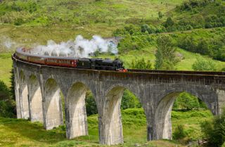 Heritage Jacobite coal fired Steam Train Hogwarts Express, used in the Harry Potter films at Glenfinnan viaduct in the Scottish Highlands