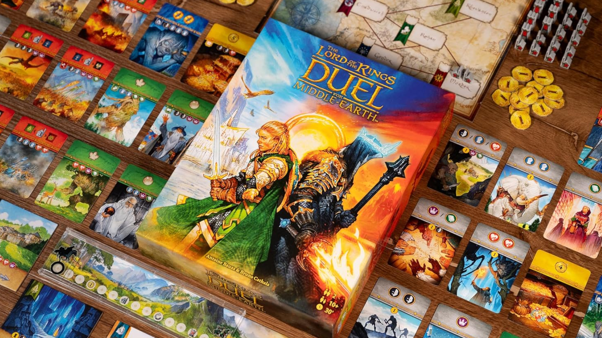 Duel for Middle-earth box lying amongst components on a wooden surface