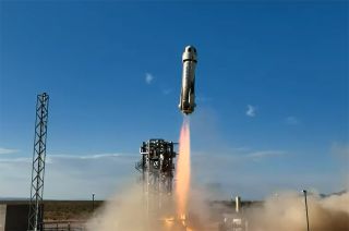 a white rocket launches into a blue sky