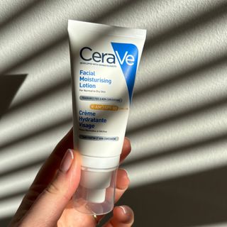 Laura holding Cerave Facial Moisturising Lotion SPF 50 - best sun creams
