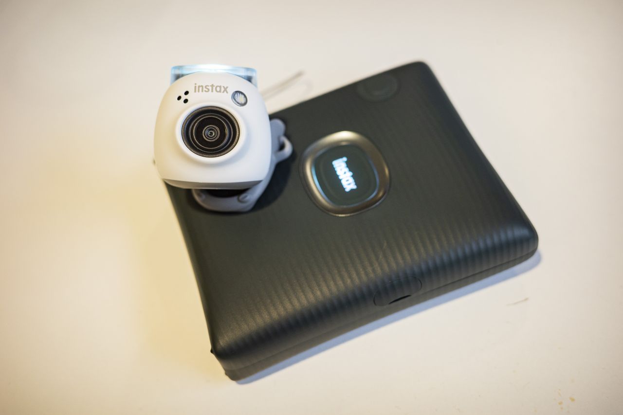 Fujifilm Instax Pal camera resting on the Instax Square Link printer