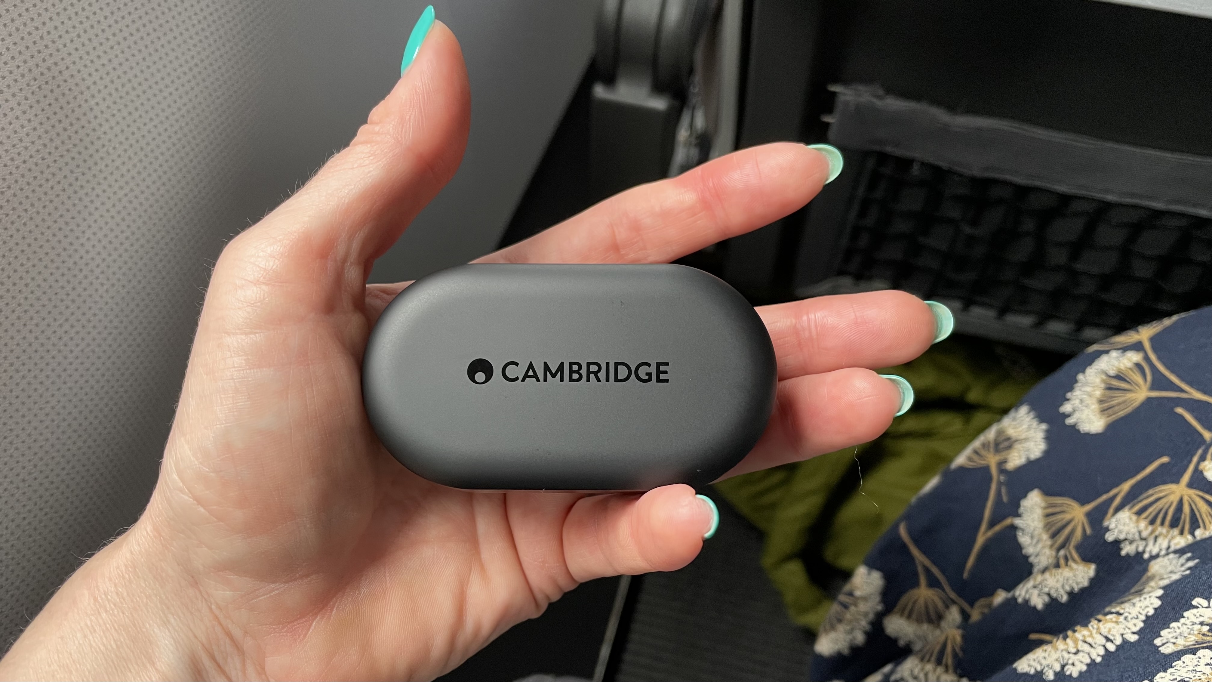 Cambridge Audio Melomania M100 case, held in a hand