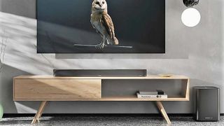 Sennheiser Ambeo Soundbar Plus on table top with TV screen above