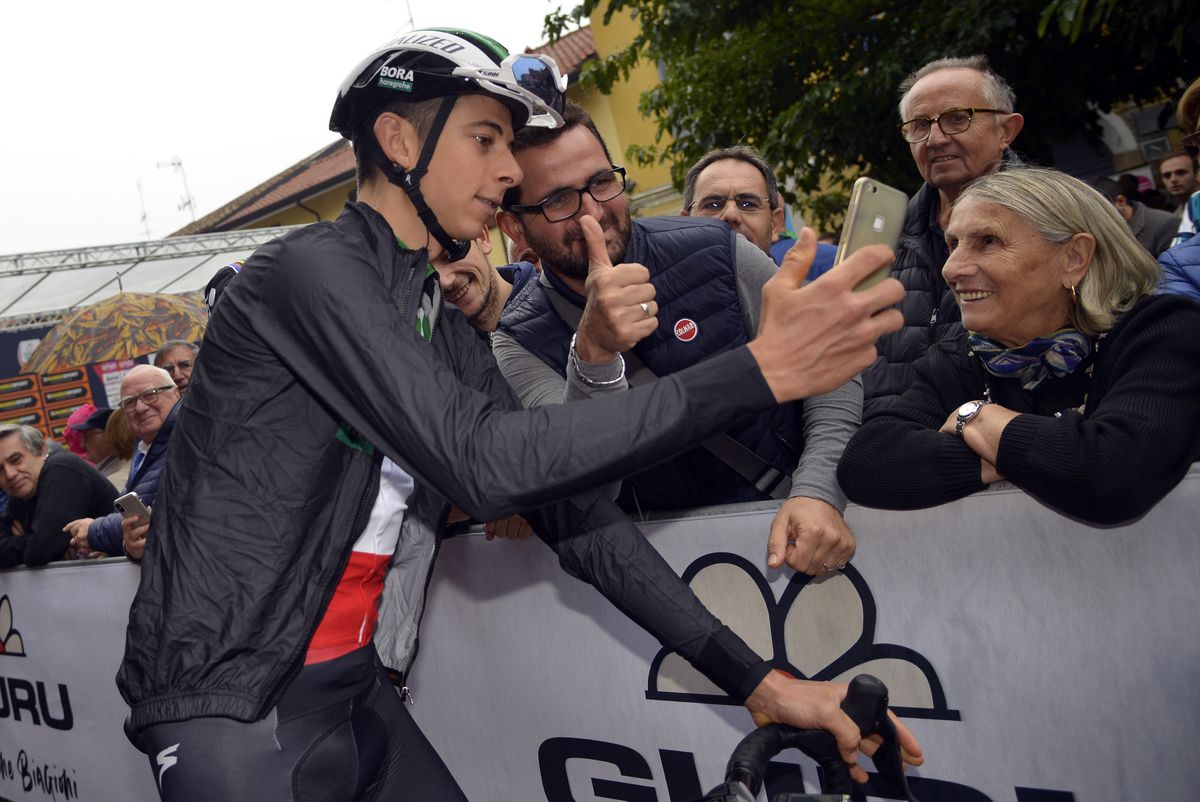 Davide Formolo (Bora-Hansgrohe) takes a selfie with fans at the start of Milano-Torino