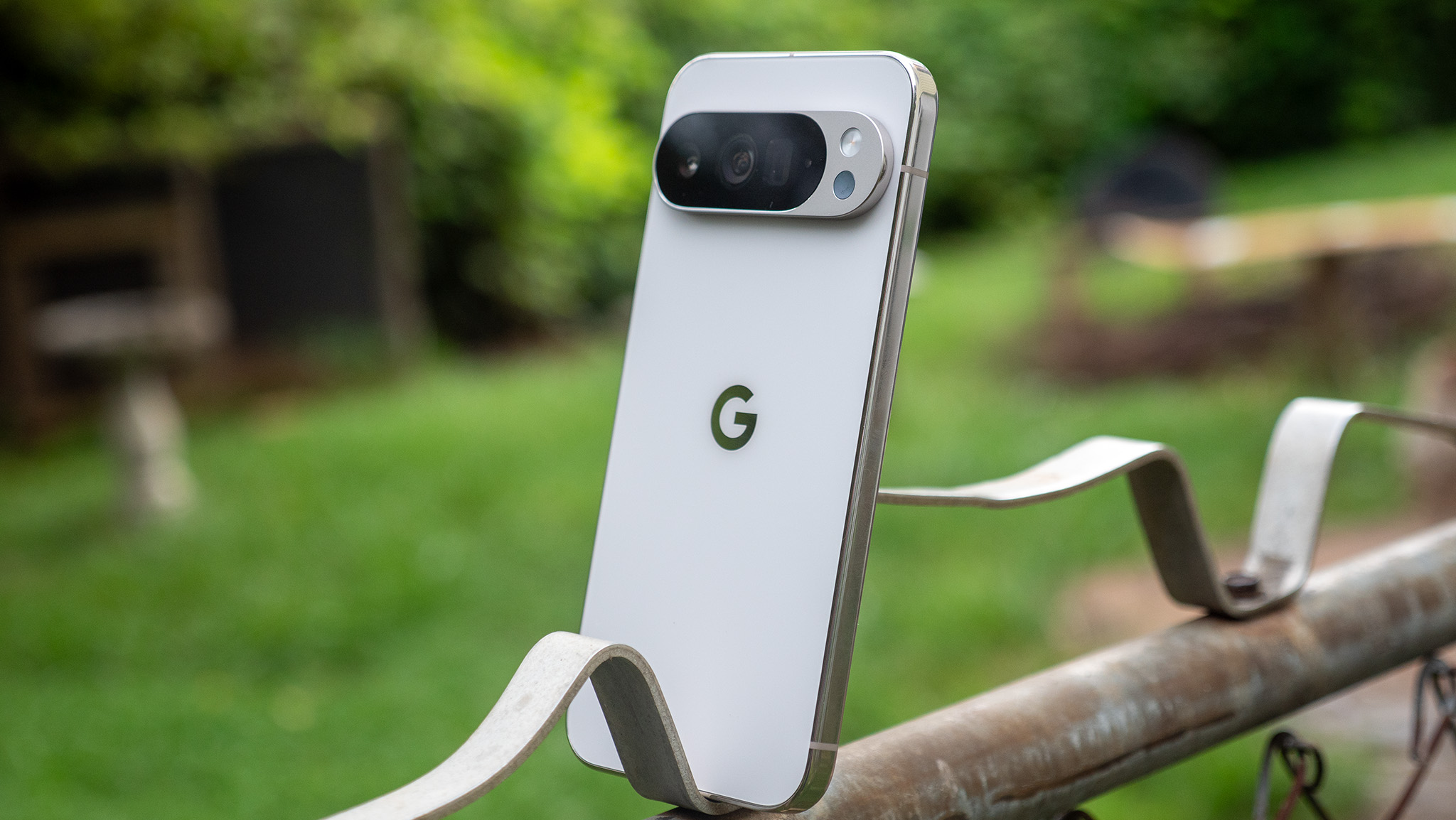 A white Google Pixel 10 Pro XL perched on a fence