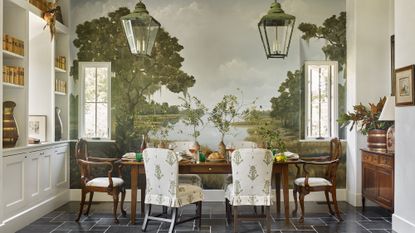 A dining room with pastoral mural, mahogany dining suite and antique lanterns
