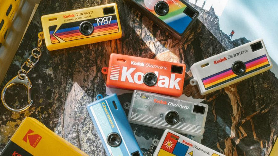 Lifestyle picture of several different colorful Kodak Charmera shot from the top down so you can see their colorful designs and keyring chains