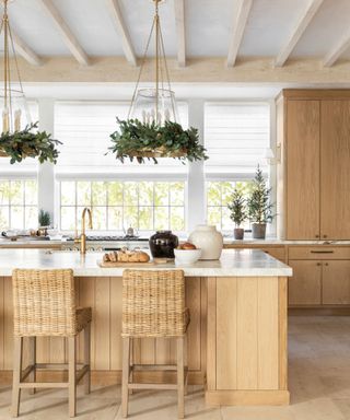 Wooden kitchen with wreaths on lighting