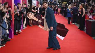 Andrew Garfield poses with a cardboard cutout of Florence Pugh at the "We Live In Time" Headline Gala during the 68th BFI London Film Festival at The Royal Festival Hall on October 17, 2024 in London, England.