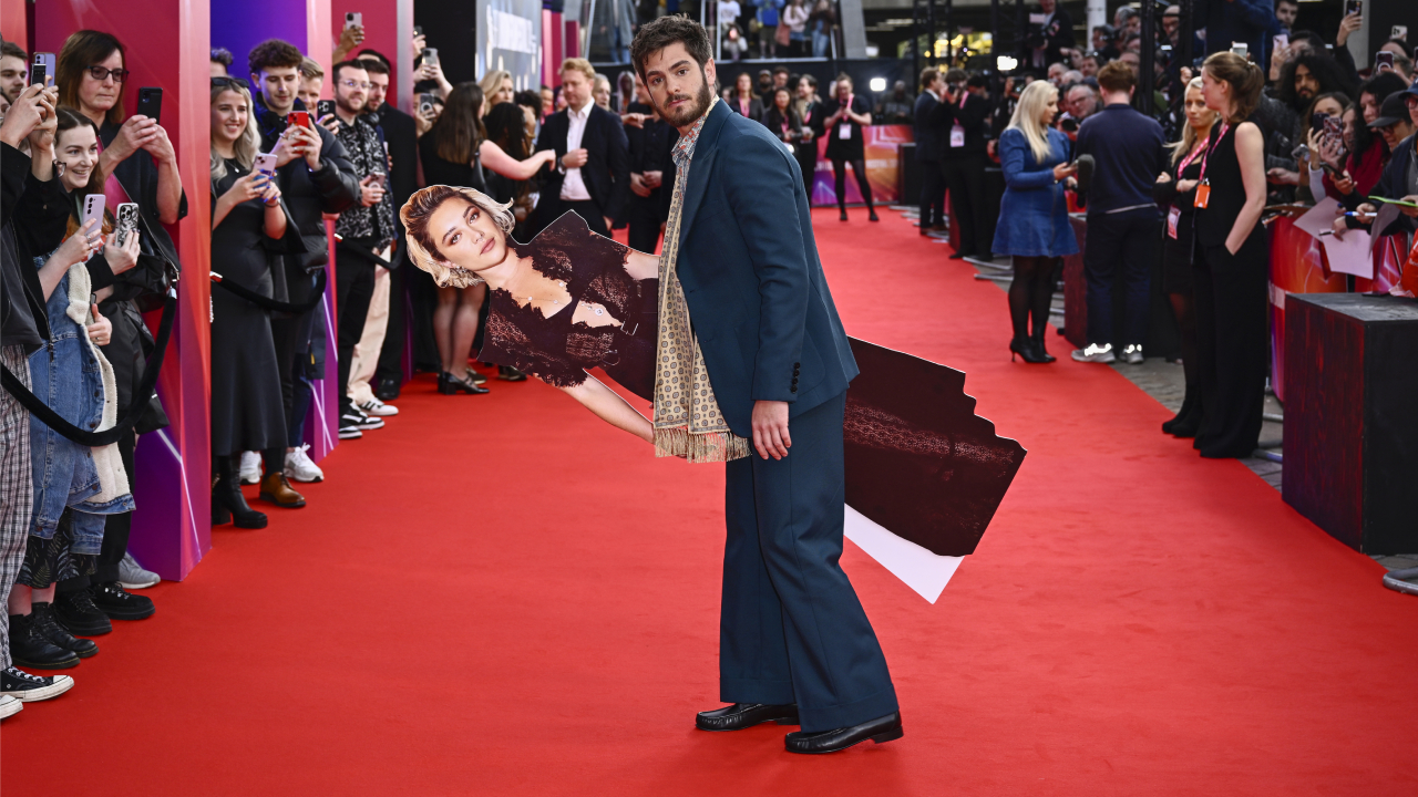 Andrew Garfield poses with a cardboard cutout of Florence Pugh at the 