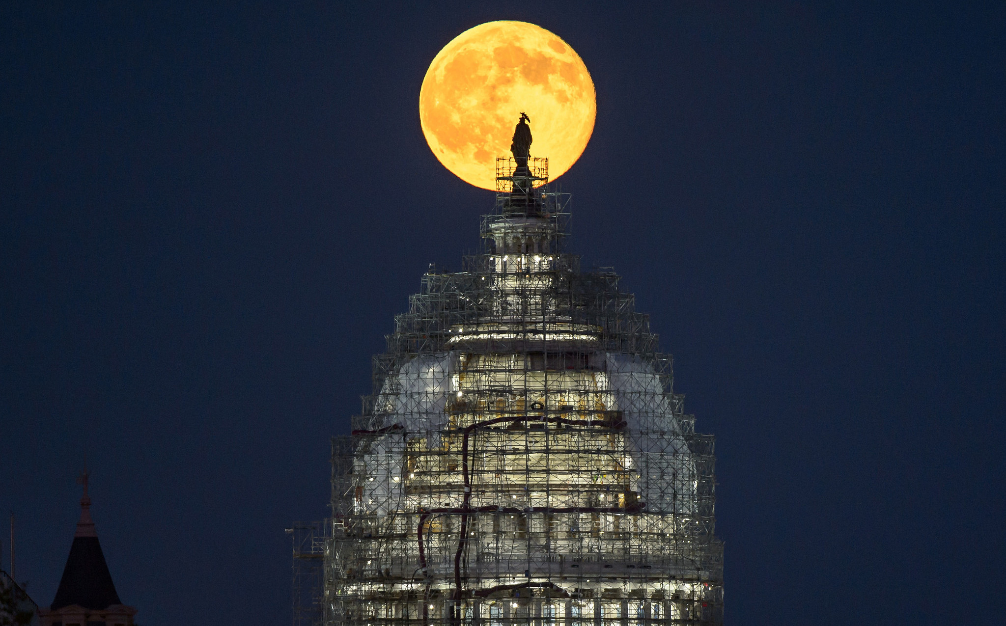 The &quot;blue moon&quot; full moon of July 31, 2015 rises behind the dome the U.S. Capitol in this image from NASA photographer Bill Ingalls. The May 21, 2016 full moon is the fourth full moon in spring, which is also known as a &quot;blue moon.&quot;