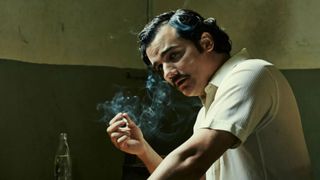 Wagner Moura as Pablo Escobar smoking during the Netflix series Narcos.