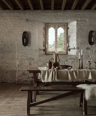 A dining room wall idea with exposed brick wall painted and rustic wooden bench